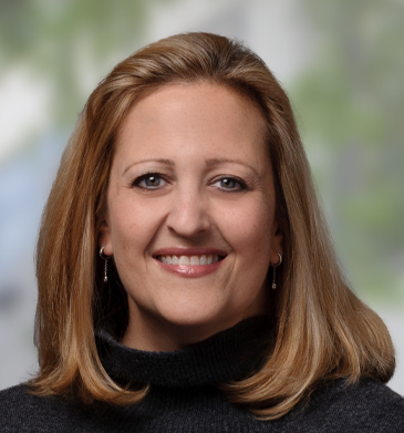 CMO Joy Schwartz headshot smiling with blond hair and black turtleneck.