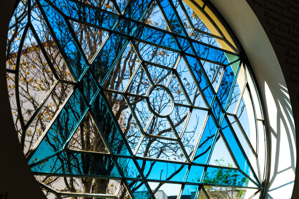 Stained glass circle window featuring a blue Jewish star
