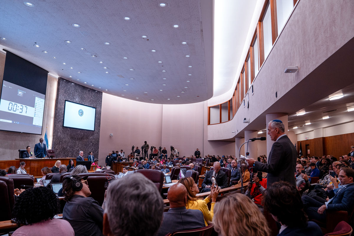 A man wearing a kippah presenting in front of a court.