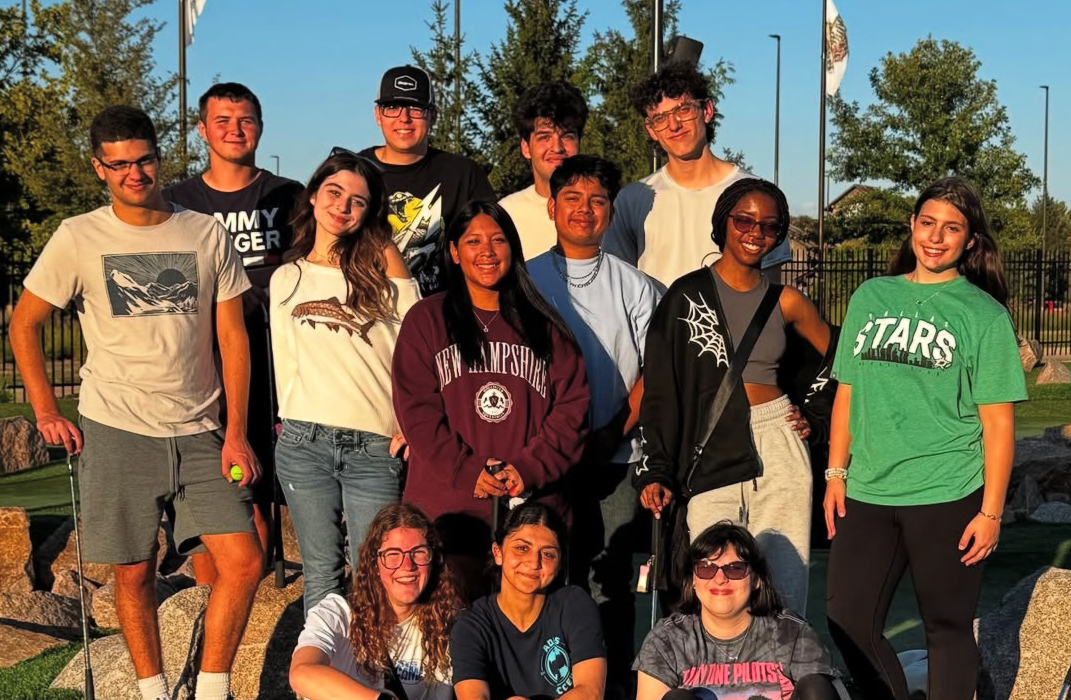 students posed outside mini golf