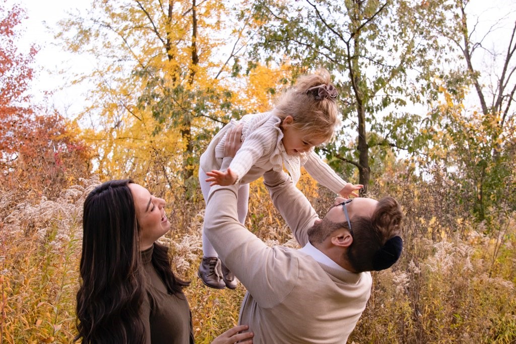 Parents with baby in the air