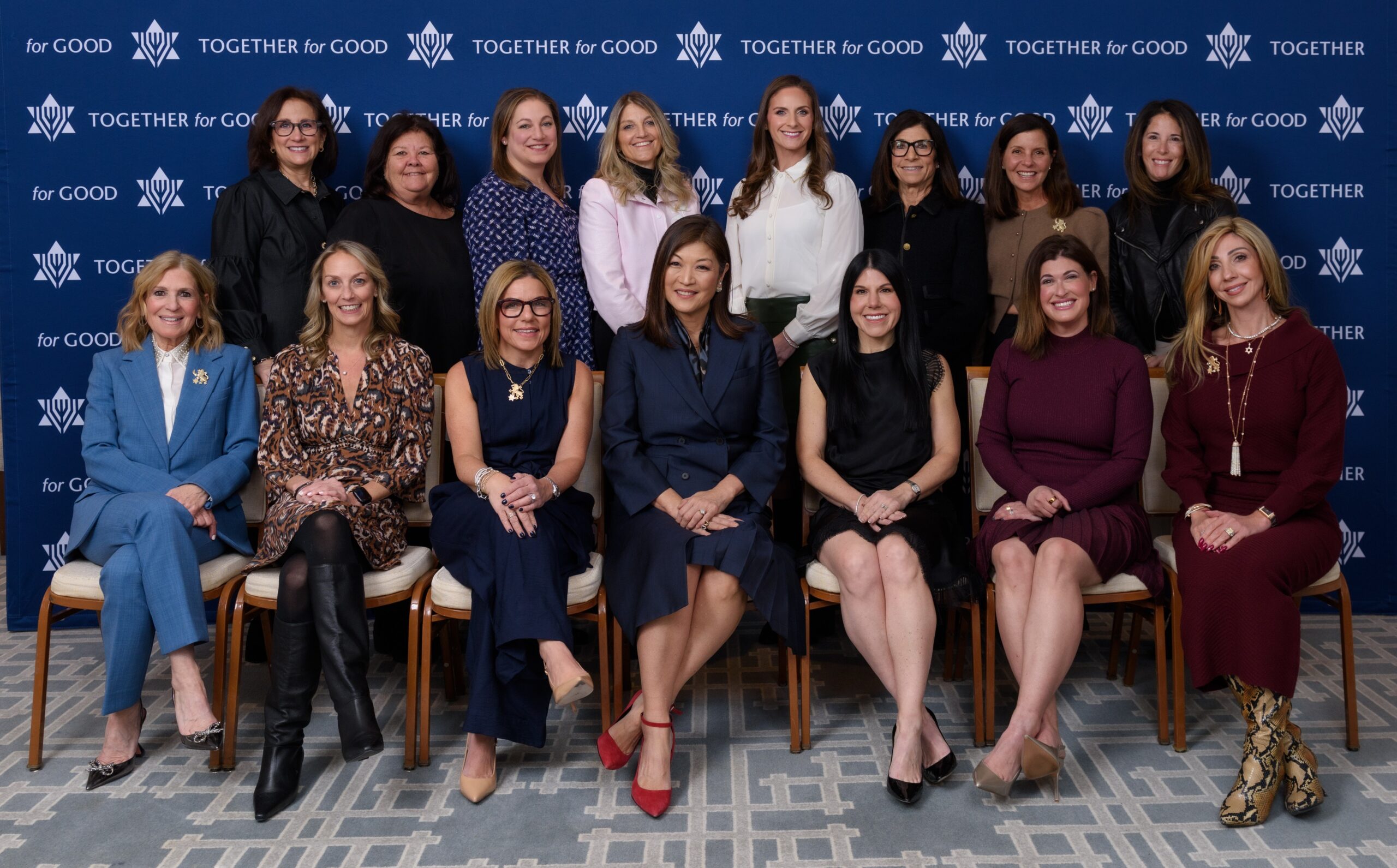A group of women's philanthropy board members posing with JuJu Chang at Grand Event.