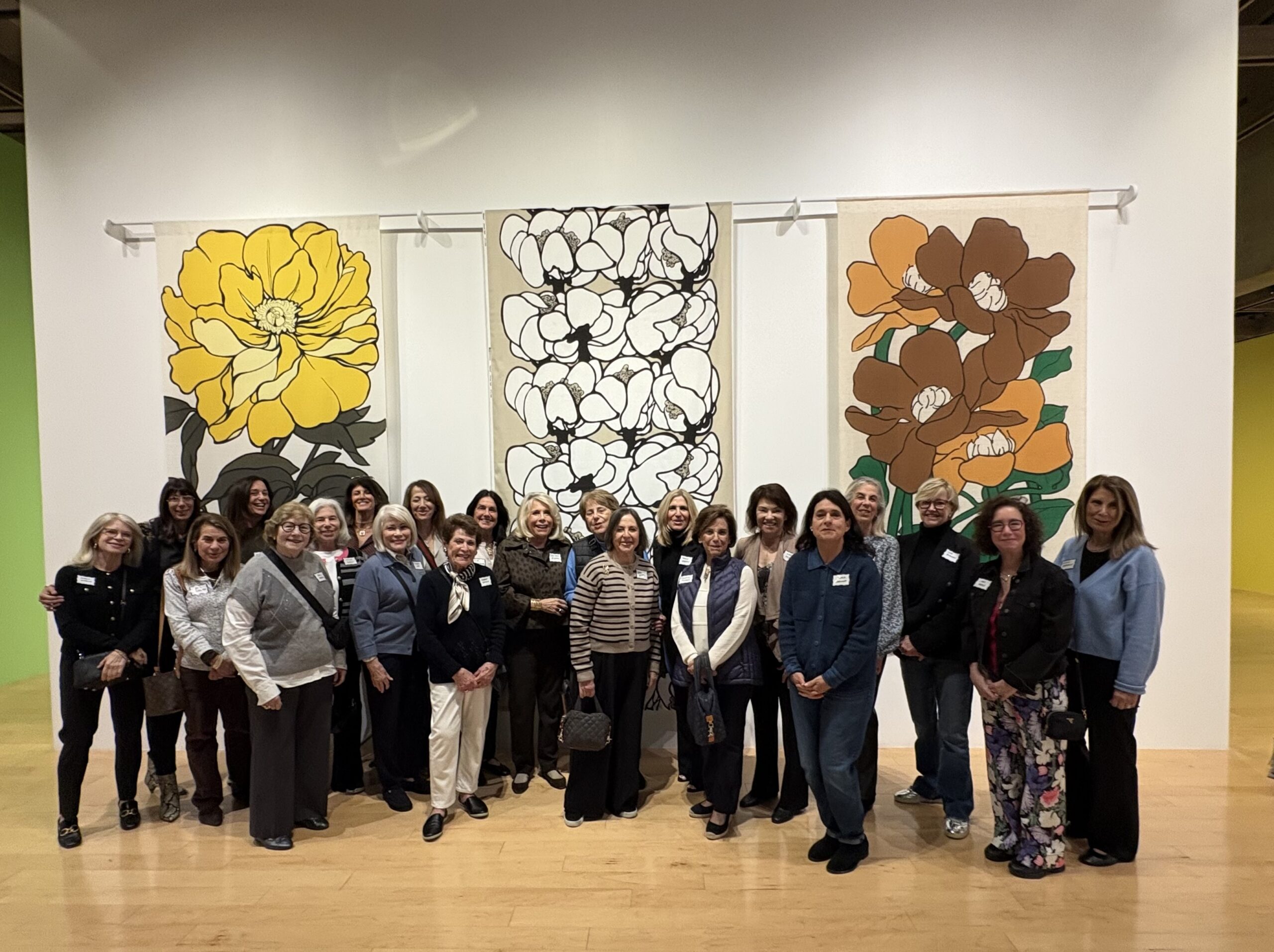 About 30 women posing for a photo at an art museum in Palm Springs.