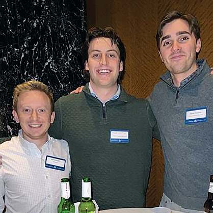 Three men in name tags at Luxbar networking.