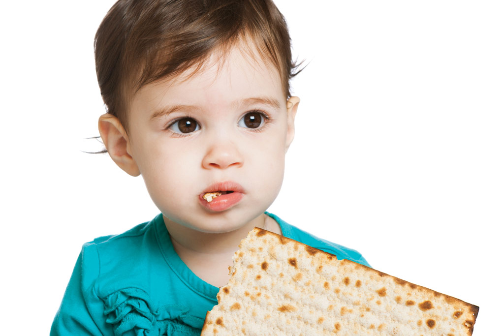 Toddler boy eating matza