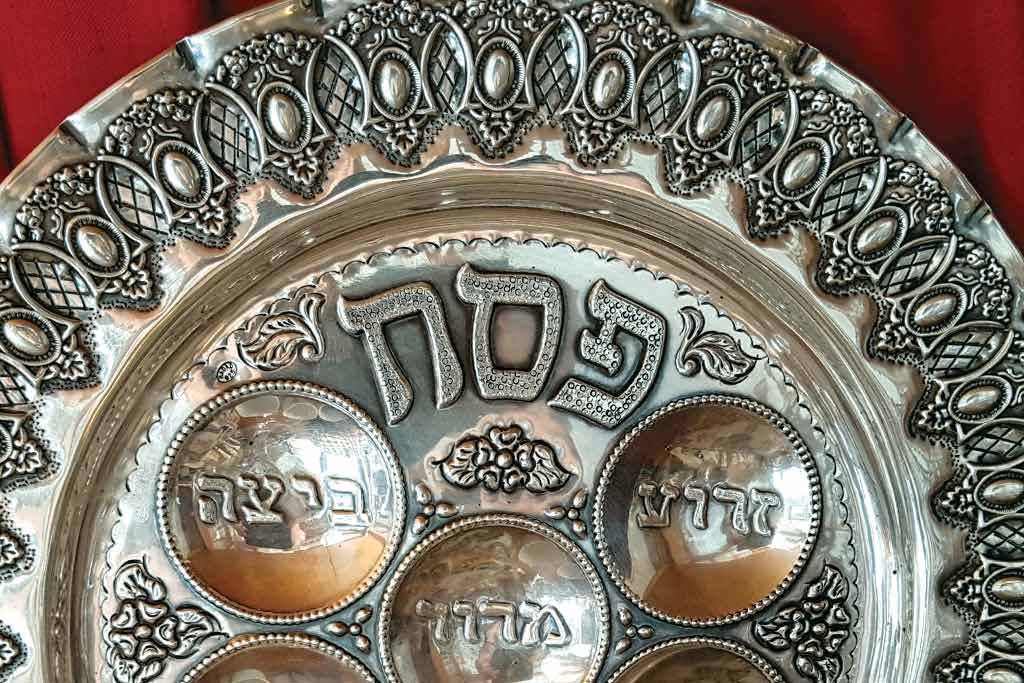 Metal seder plate reading "Passover" in hebrew