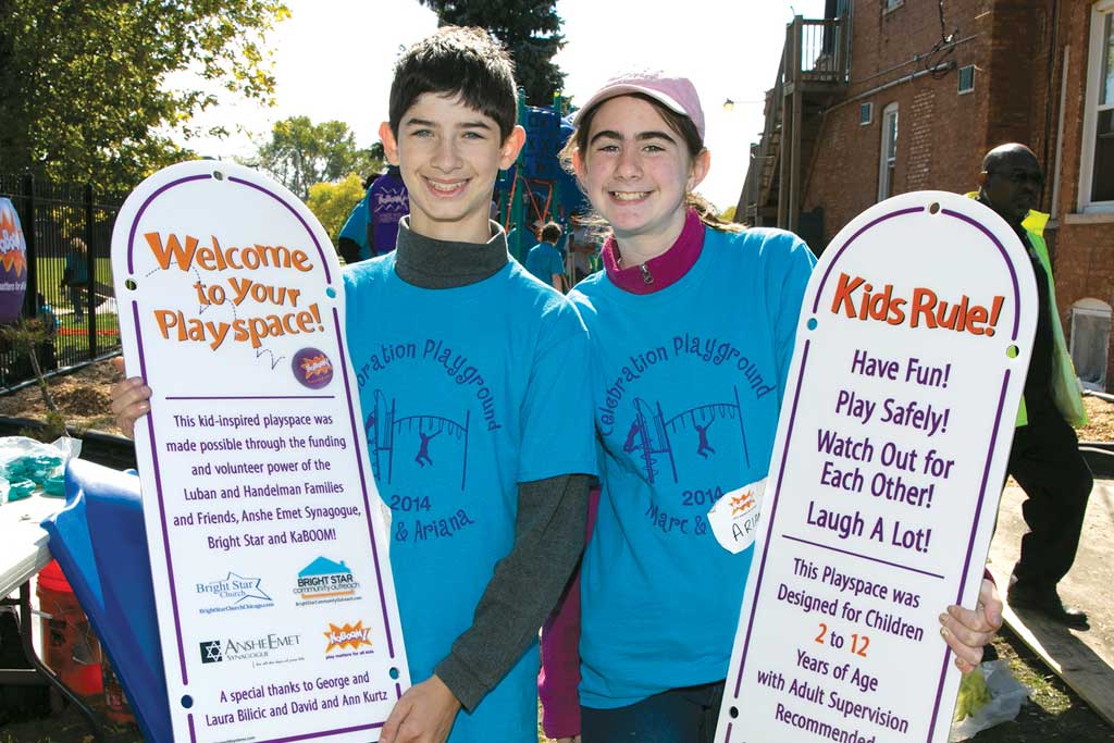 Marc Luban and Ariana Handelman on the day of their combined bar and bat mitzvah party: helping to build a playground. (Photo credit: Photography by Frederic P. Eckhouse)