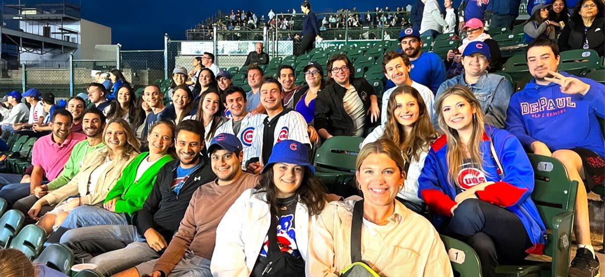 A group of Young Leadership Division participants at a cubs game in the bleachers.