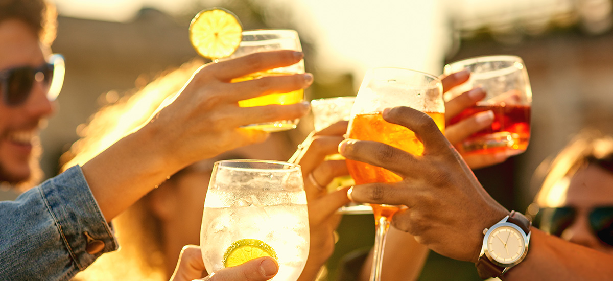 People clinking glasses together in cheers.