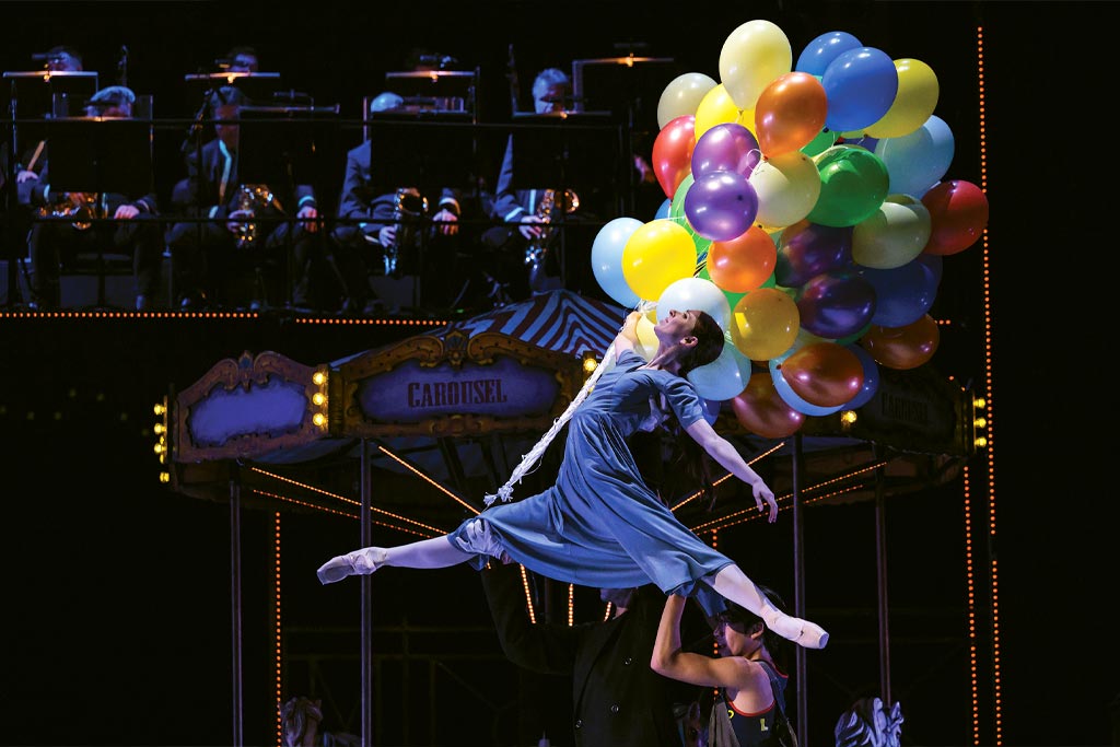 a photo of a women in ballet holding baloons