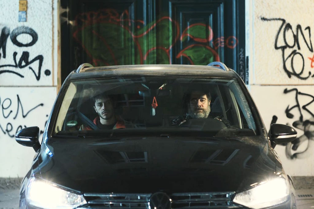a photo of a two people in a black car