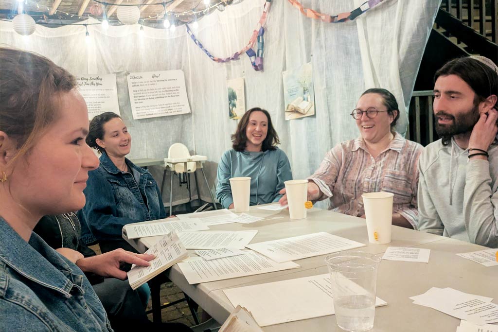 A photo of Base Hillel participants sitting at a table