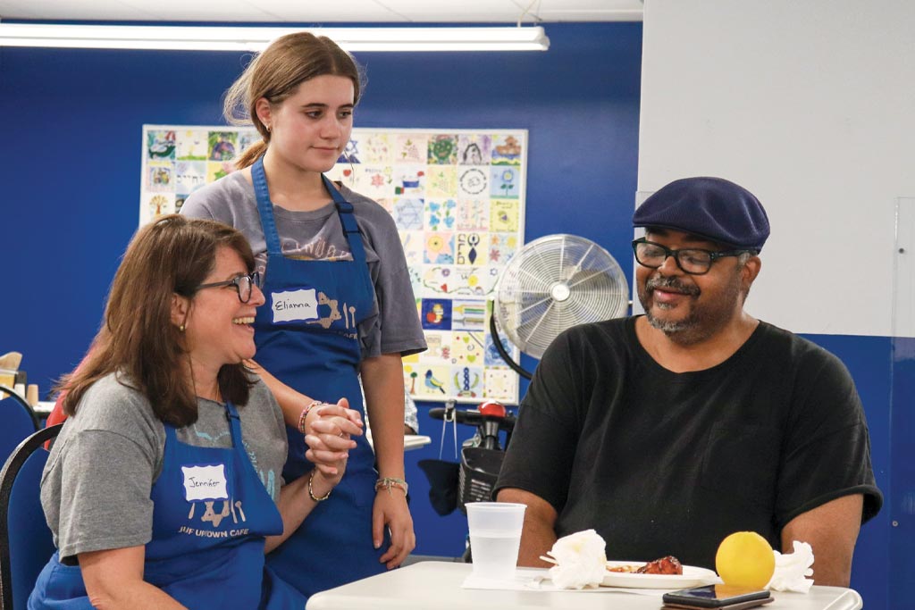 A photo of two volunteers at JUF's Uptown Cafe
