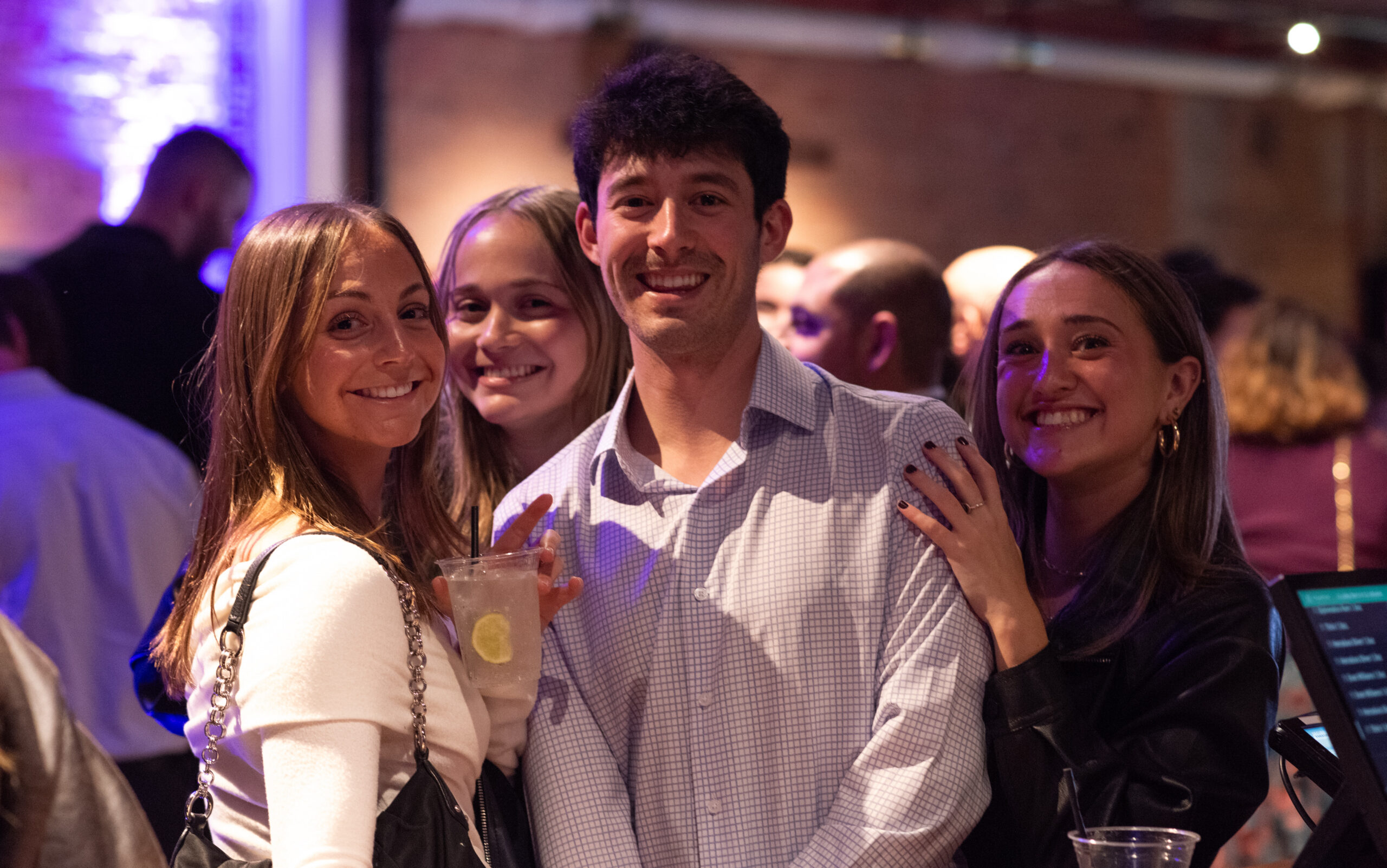 A photo of four people smiling