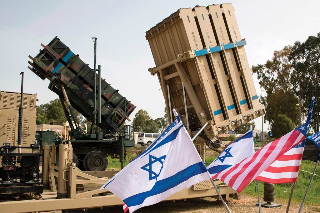 A photo of an Israeli Iron Dome anti-rocket system and an American Patriot missile defense system are shown during a joint U.S.-Israel military exercise.