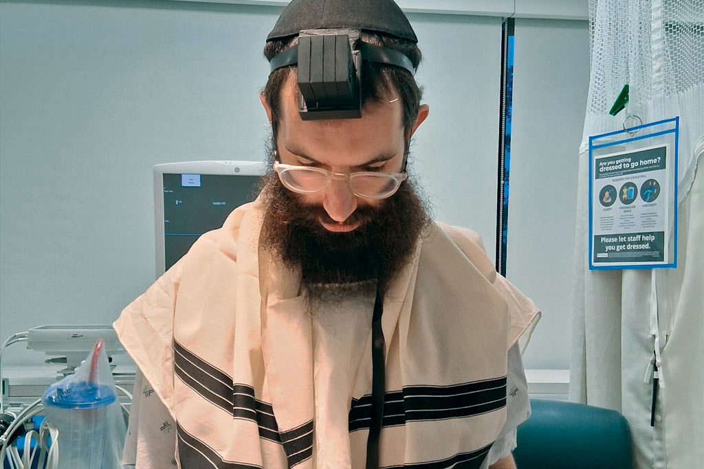 A photo of a rabbi wrapped in a talit.