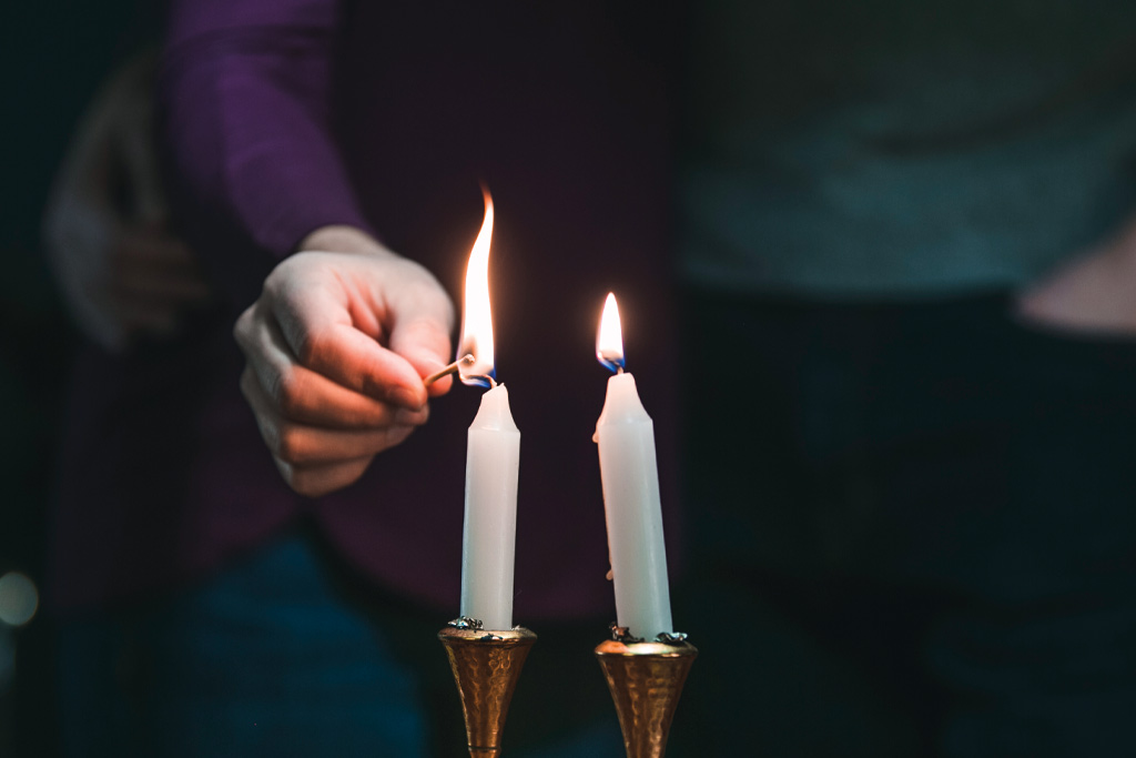 A photo of someone lighting candles