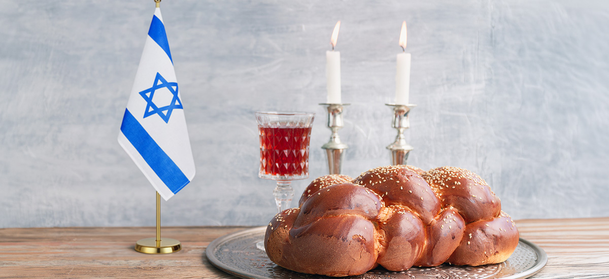 A photo of challah and candles