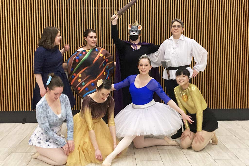 A photo of Adina Stuhlman, in blue and white as the Chanukah Fairy, and the rest of her cast for their 2024 ballet performance of The Jewish Nutcracker.