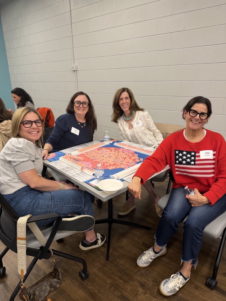 A photo of four women at Women&rsquo;s City Council and Women&rsquo;s Board gathered for a joint Game Night