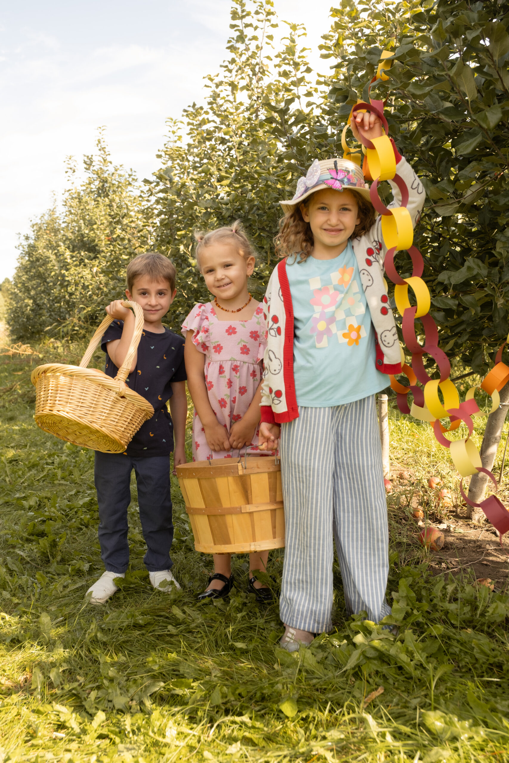 A photo of three children apple picking